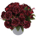 Burgundy artificial peonies in a gray vase, front view. The bouquet features multiple flower heads and green leaves.