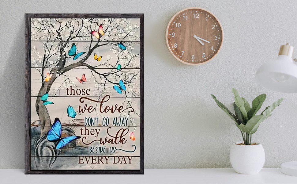 Framed butterfly diamond painting with inspirational quote on a wall next to a clock and lamp.