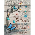 Butterfly diamond painting kit with quote 'Those we love don't go away they walk beside us every day' on a wooden background.