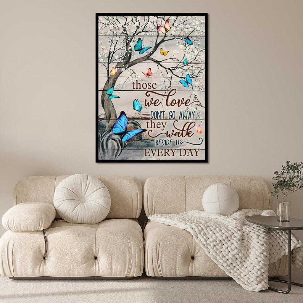 Diamond painting artwork of a tree with butterflies and inspirational quote on a wooden plank background, displayed above a sofa.