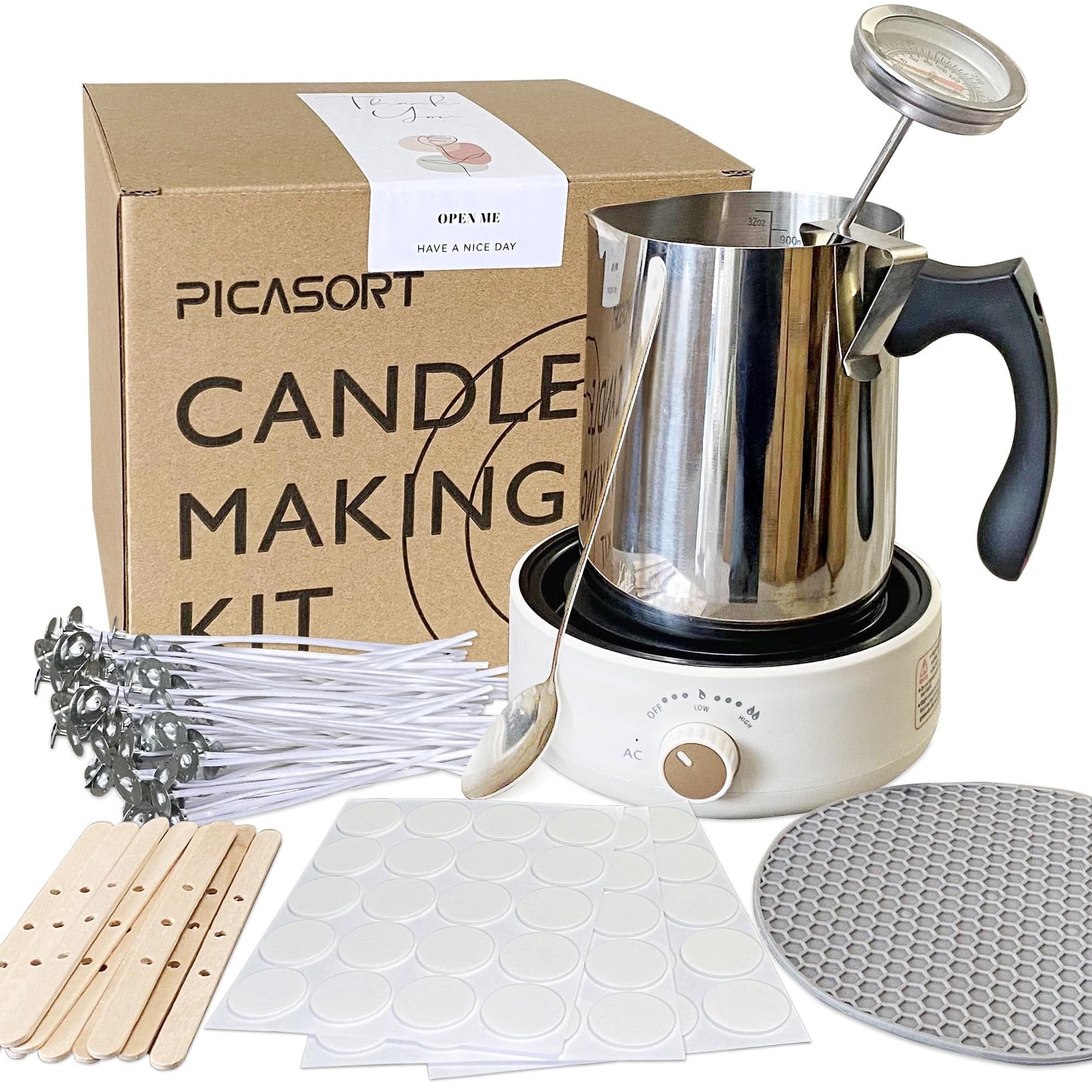 Candle making kit contents including a melting pot with thermometer, hot plate, wicks, wooden sticks, and stickers.