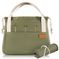 Green canvas crochet bag organizer with white handles and a rolled-up pouch of yarn and needles in front.