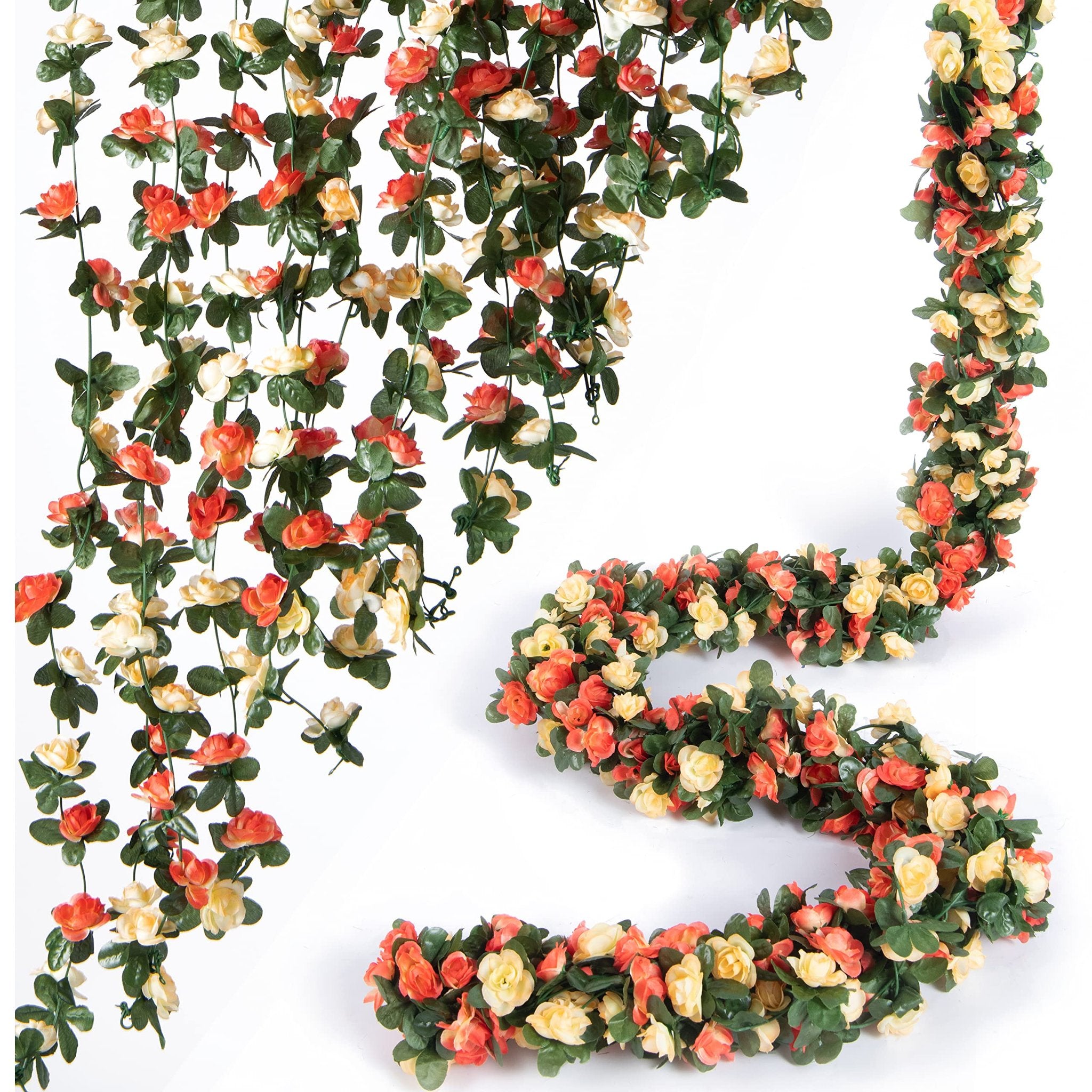 Champagne artificial rose vine garland with green leaves, displayed in hanging and coiled arrangements on a white background.