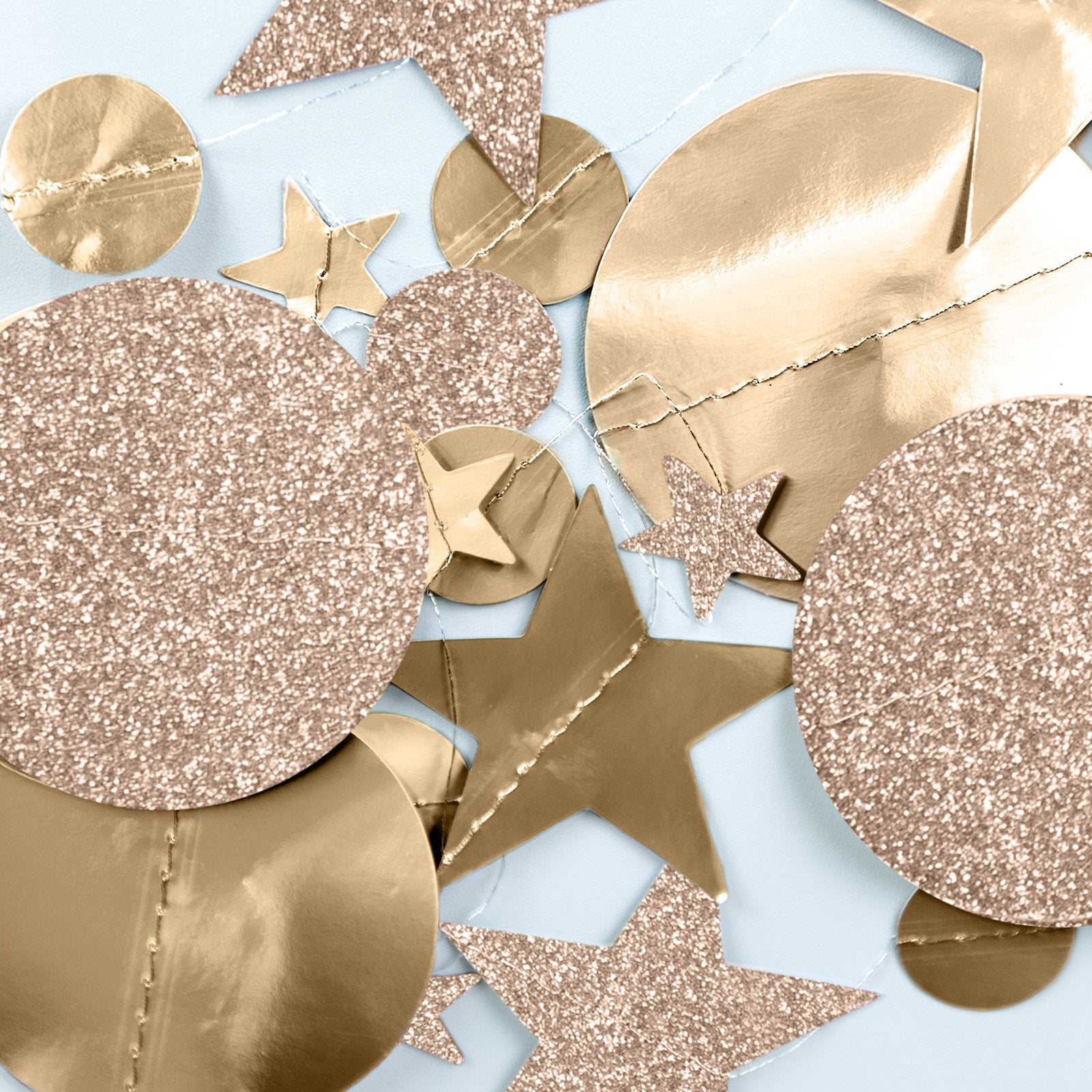 Champagne gold glitter and metallic stars and circles hanging decor close-up