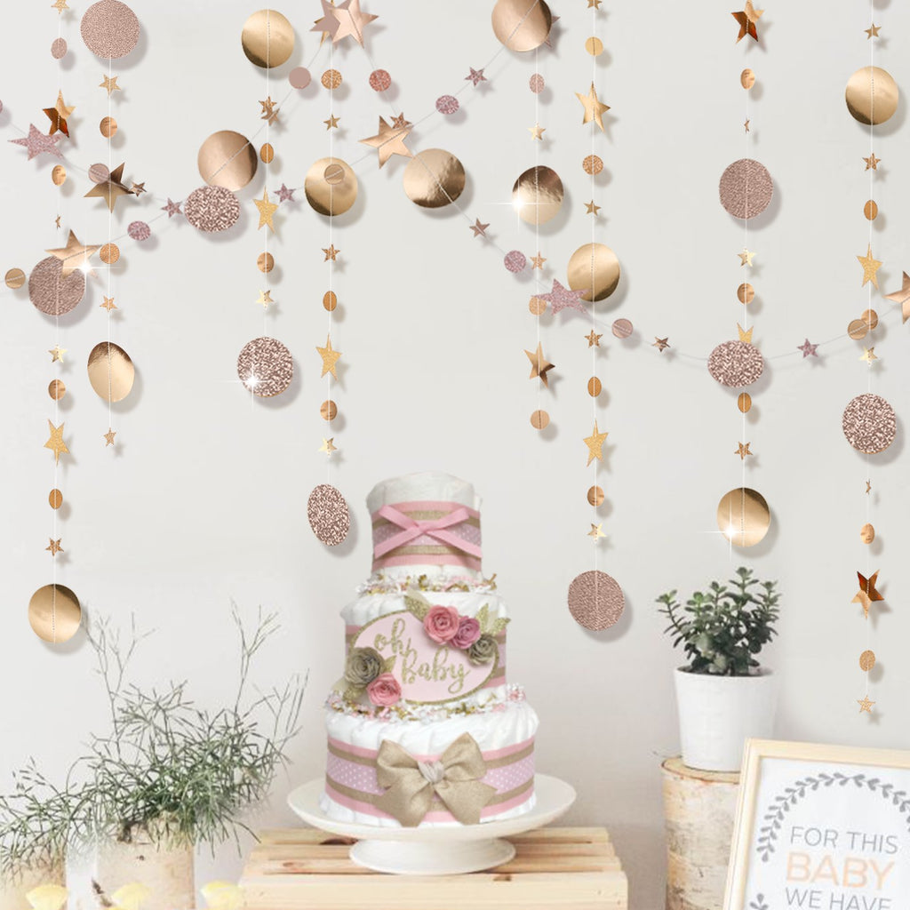 Champagne gold star and circle garland hanging above a diaper cake with 'oh baby' text