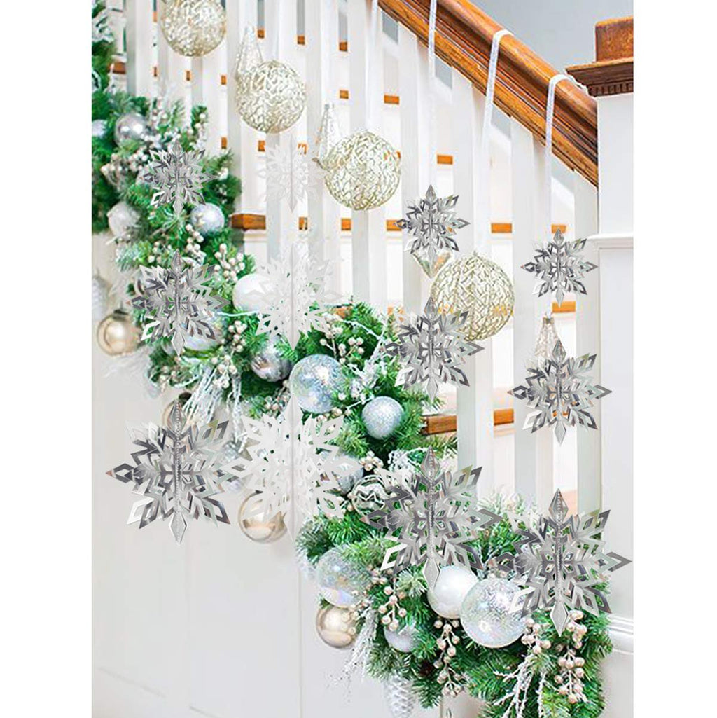 Christmas garland with white and silver paper snowflakes and ornaments draped on a staircase railing