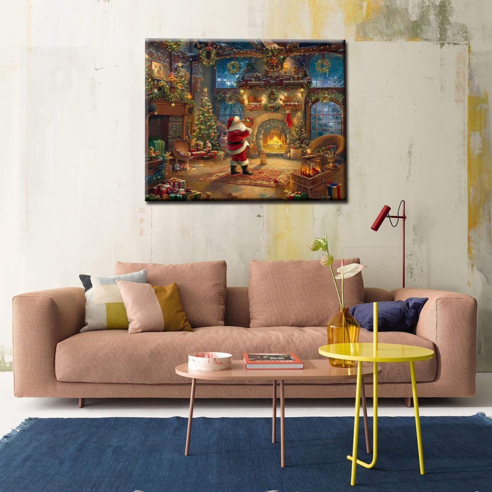 Christmas scene painting of Santa by a fireplace with Christmas trees and gifts, displayed above a sofa.