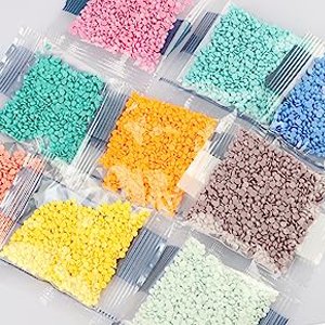 Diamond painting kit with multiple small bags of colorful round drills, including pink, green, orange, yellow, blue, and purple.