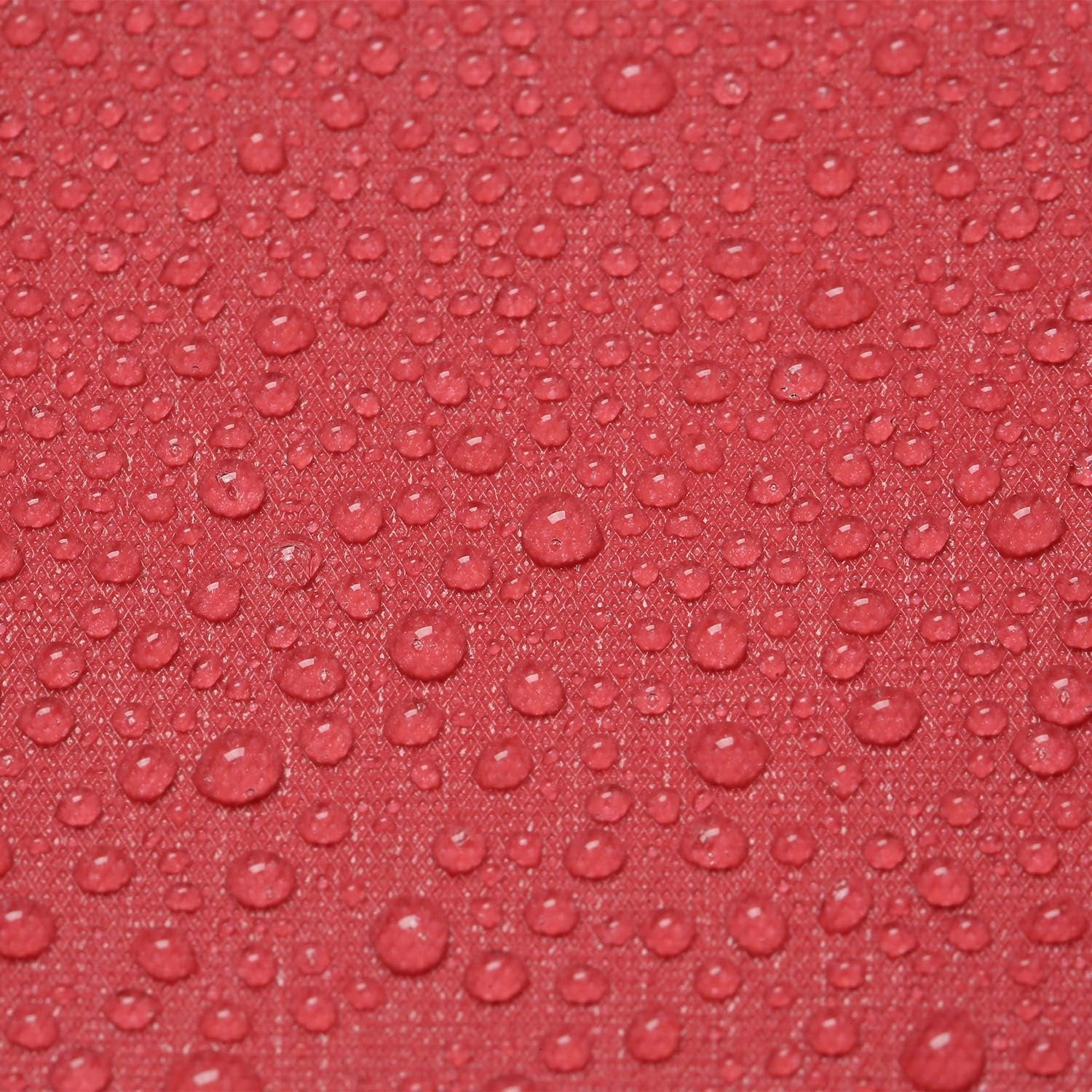 Close-up of red fabric with numerous water droplets, showing texture and water resistance.