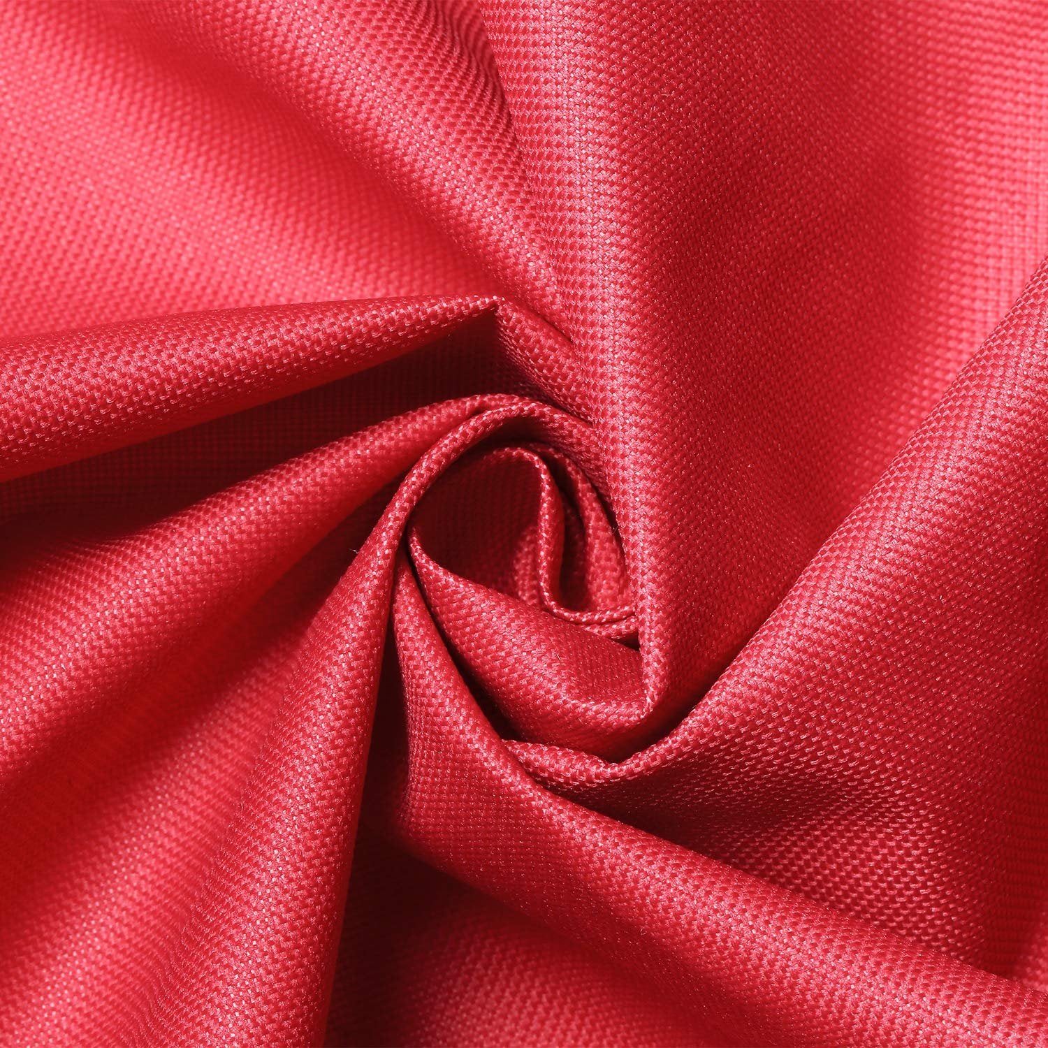 Close-up of red textured fabric with a swirl pattern, showing the weave detail.