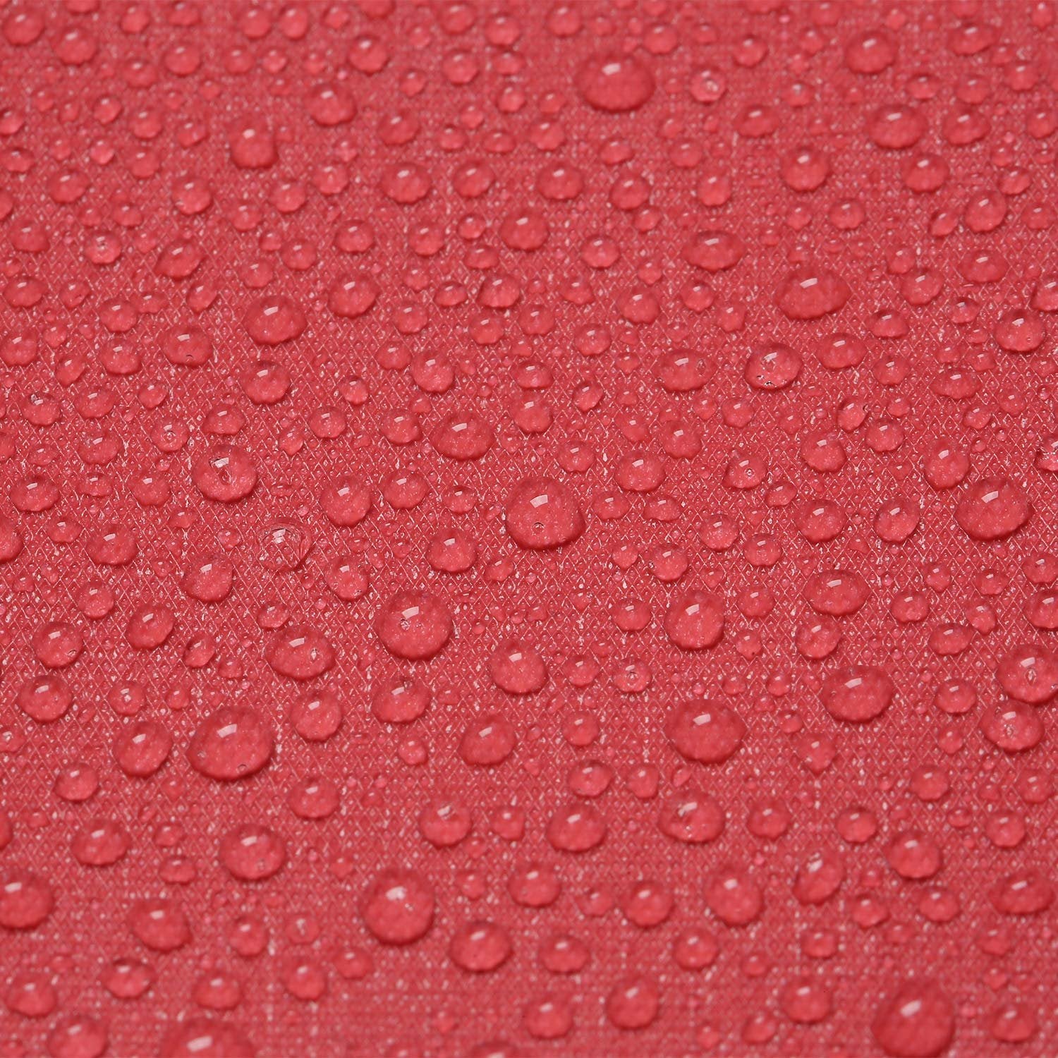 Close-up of red fabric with water droplets showing texture and water-repellent properties