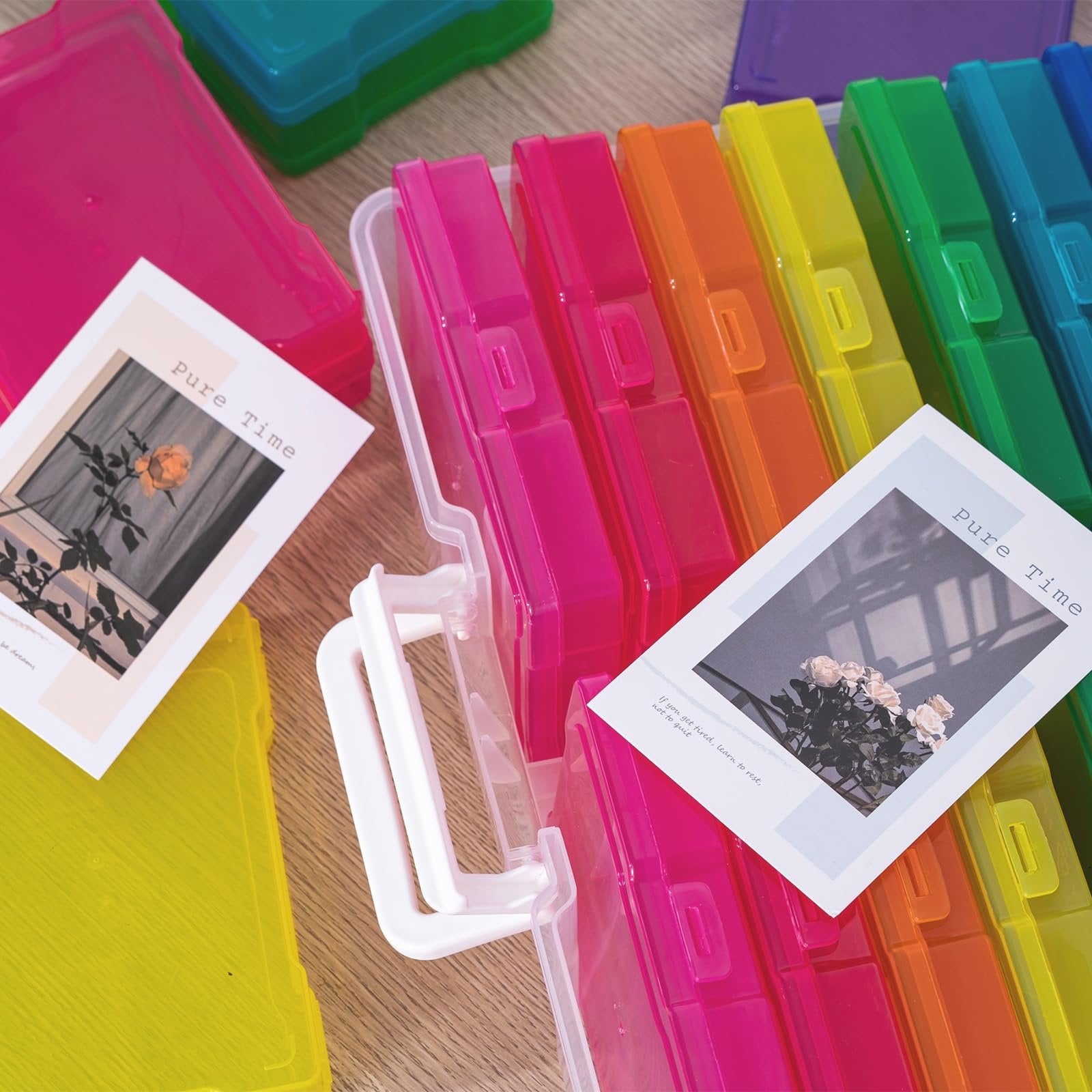 Stack of colorful photo storage boxes with handles, some with snap-tight lids, and decorative cards.