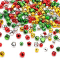 Scattered colorful jingle bells in red, green, gold, and silver on a white background.