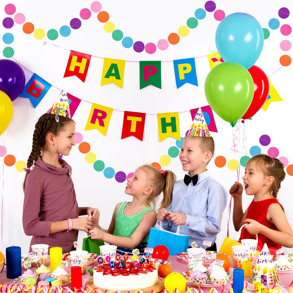 Children celebrating a birthday party with colorful decorations, balloons, cake, and cupcakes.
