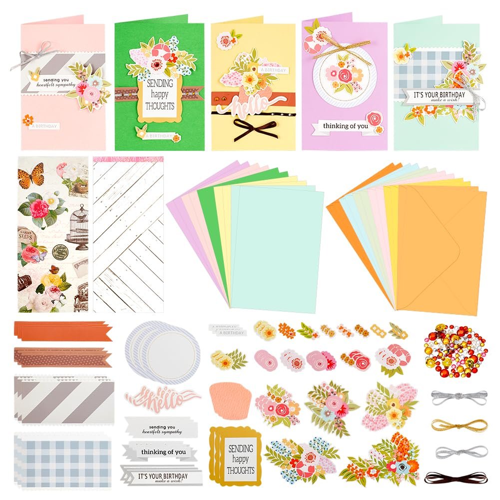 Card making kit with blank cards, envelopes, decorative papers, stickers, ribbons, and embellishments.