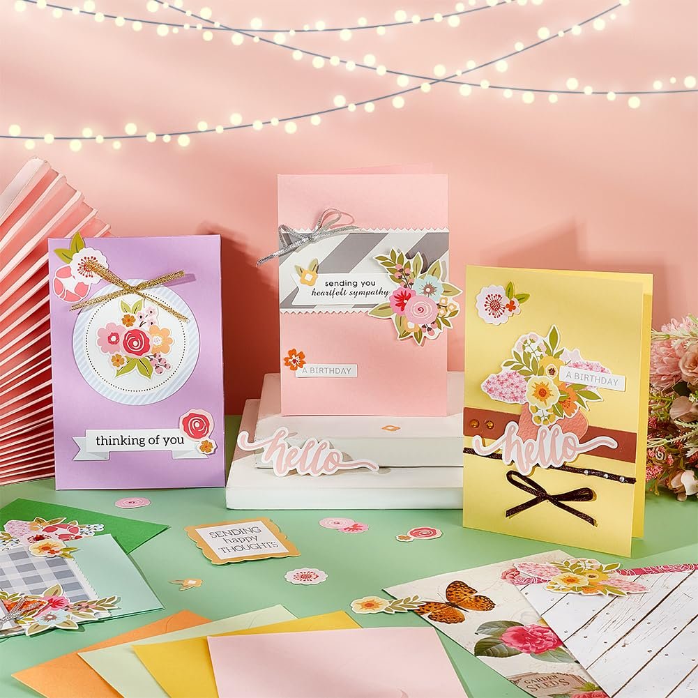 Card making kit with various greeting cards, envelopes, and decorative elements arranged on a table.