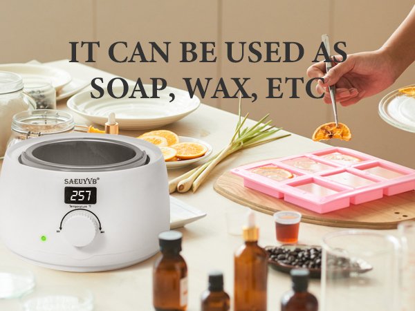 White wax melter with logo and digital display, next to a pink soap mold with orange slices.