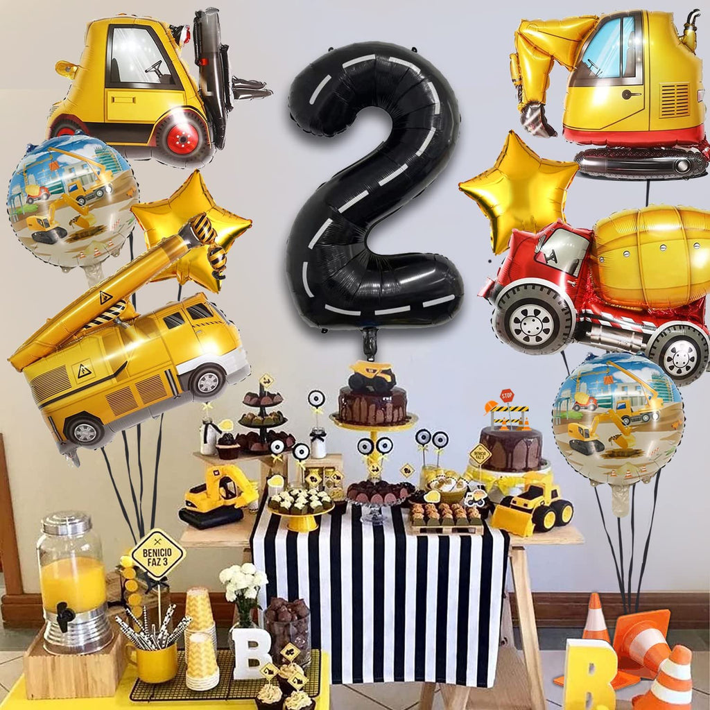 Construction truck balloons and a large number 2 balloon for a 2nd birthday party setup.