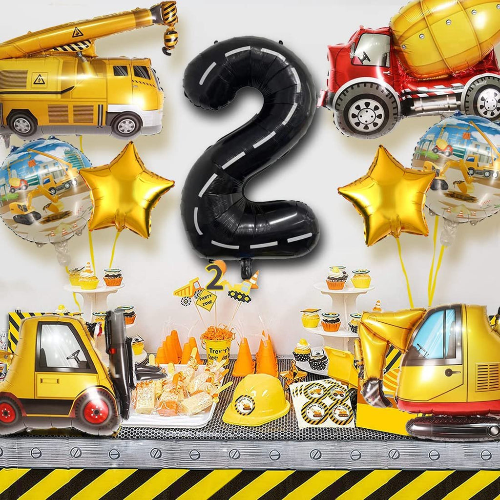 Construction truck themed 2nd birthday party decorations including balloons, cupcakes, and party favors.