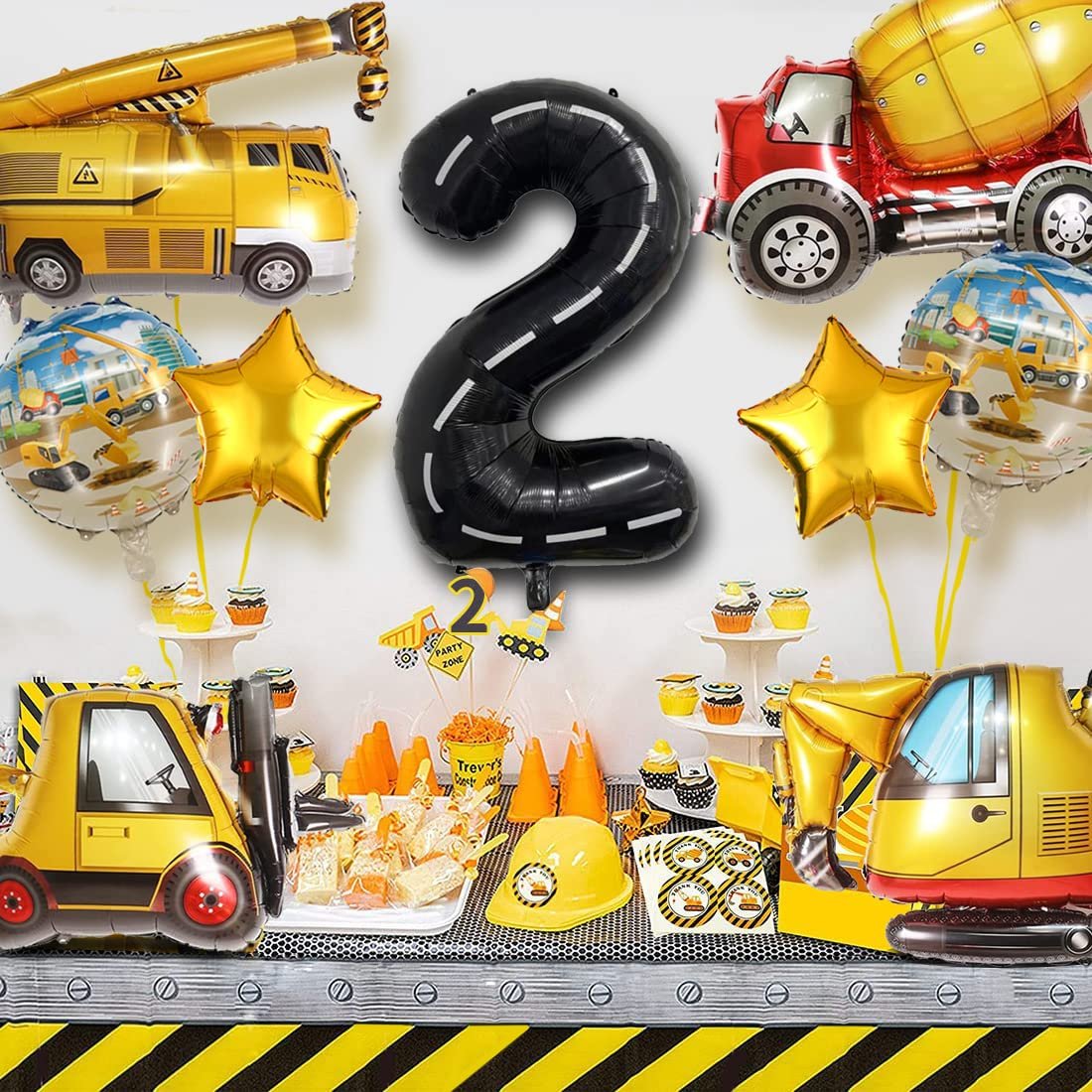 Construction truck themed 2nd birthday party decorations including balloons, cupcakes, and party favors.
