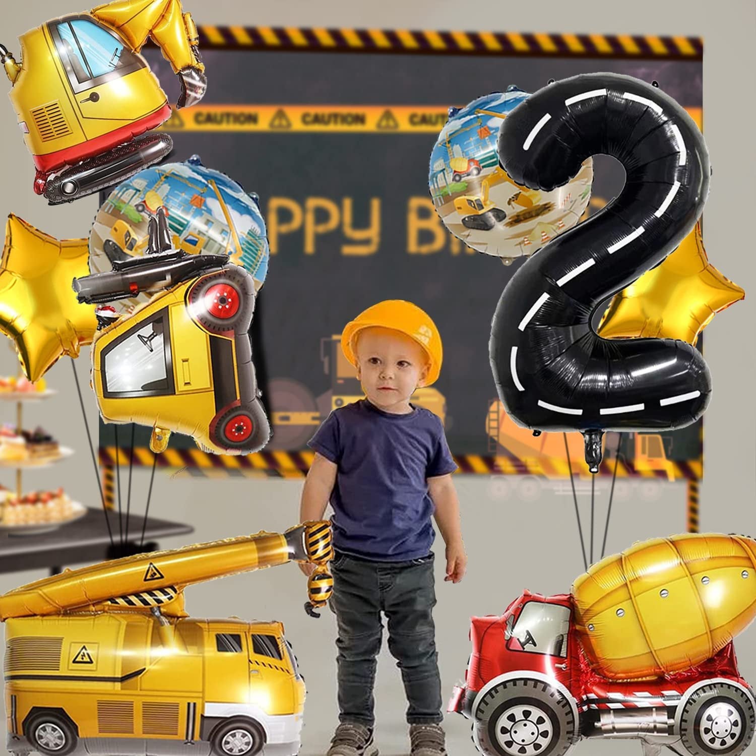Construction truck balloons and a child wearing a yellow hard hat for a 2nd birthday party.