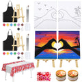 Couples date night painting kit contents including canvases, paints, brushes, easels, aprons, tablecloth, and candles.