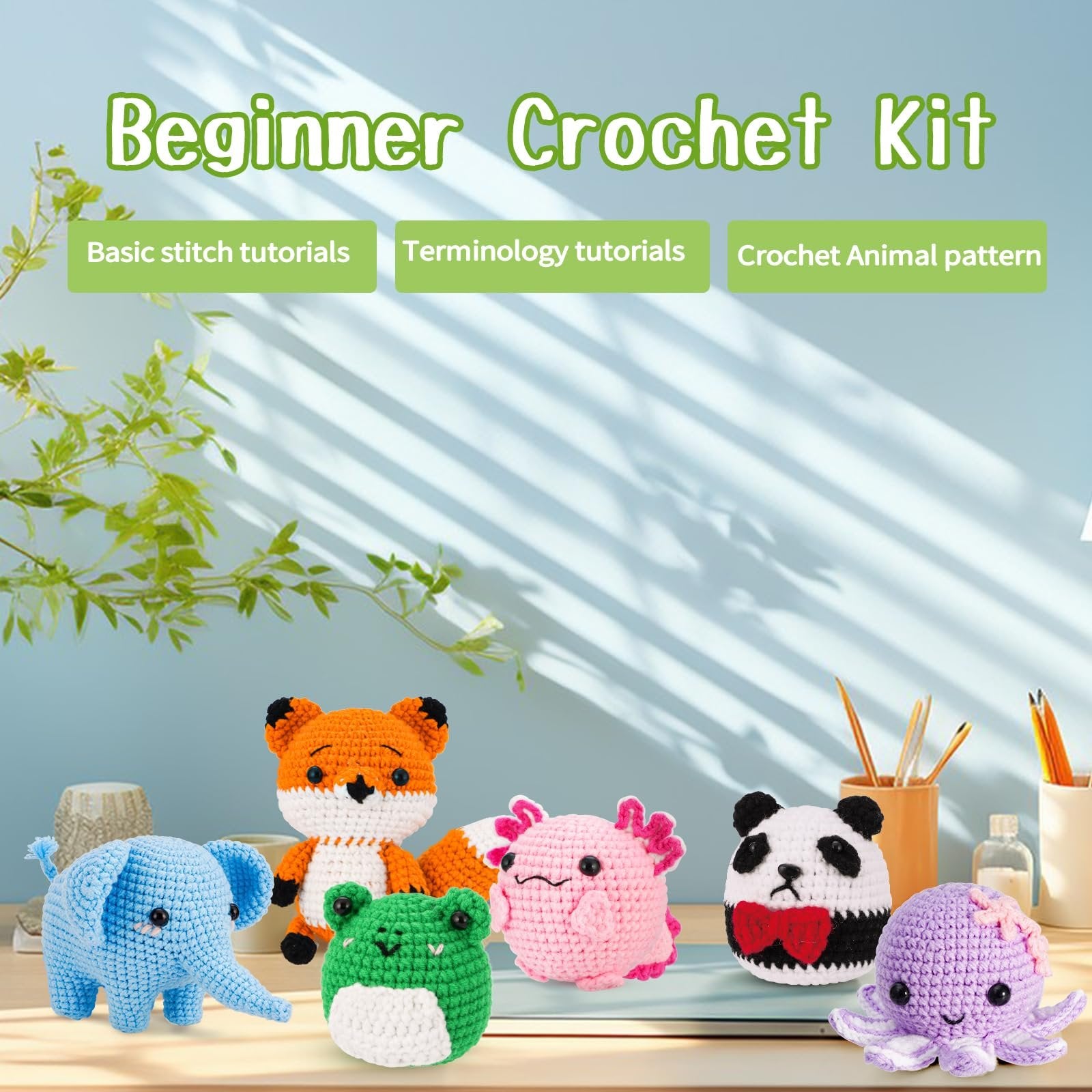 Crochet kit animals including a fox, elephant, frog, axolotl, panda, and octopus on a table.