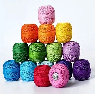 Stack of 15 colorful cotton crochet thread balls in pink, orange, yellow, green, purple, blue, and red.