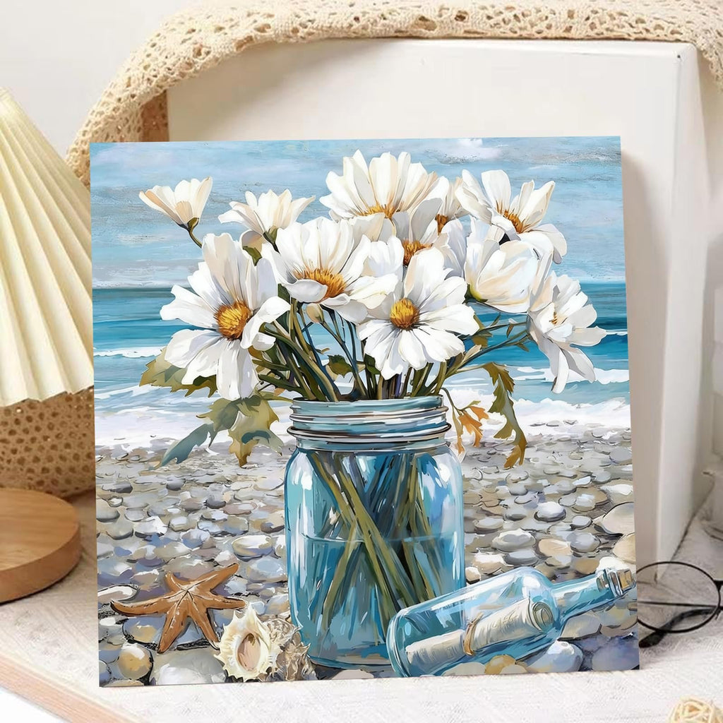 Paint by numbers canvas showing white daisies in a blue mason jar on a pebble beach with a message in a bottle.