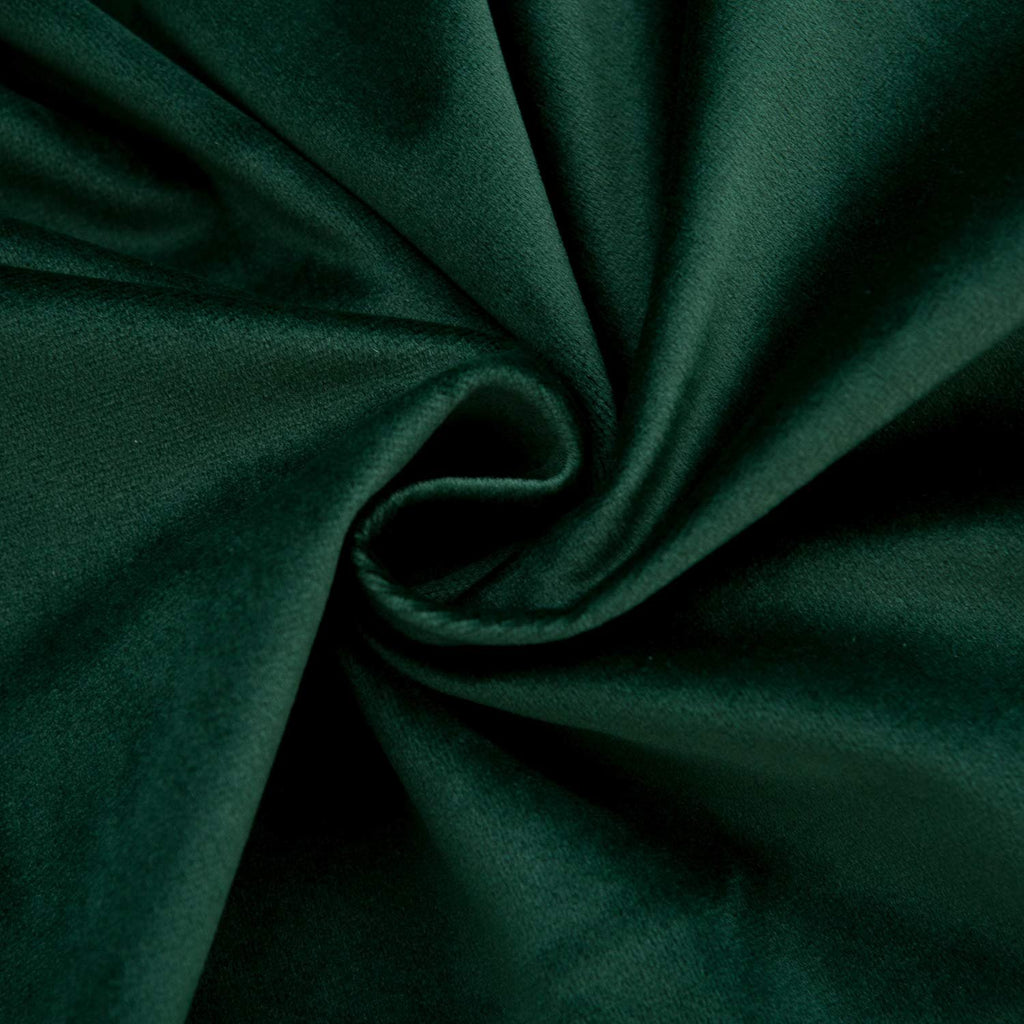 Dark green velvet fabric swatch with soft folds and a swirling texture.
