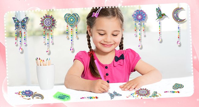 Young girl creating diamond art suncatchers including butterfly, heart, hummingbird, and moon shapes.