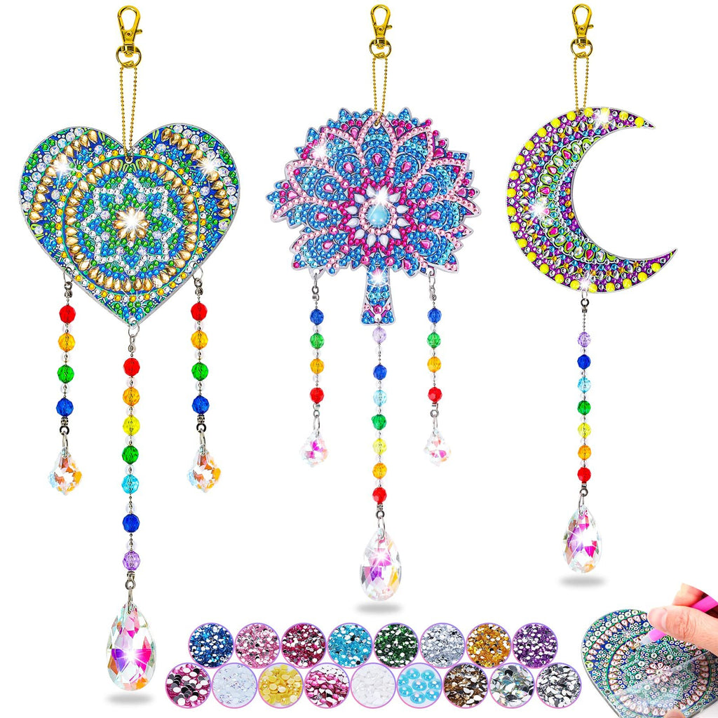 Diamond art wind chime kit with heart, tree, and moon shapes, plus gem samples and a hand applying gems.