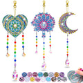 Diamond art wind chime kit with heart, tree, and moon shapes, plus gem samples and a hand applying gems.