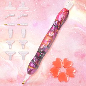 Diamond painting drill pen kit with multiple interchangeable tips and heart-shaped beads on a pink marbled background.
