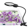 Diamond painting LED magnifier lamp with clip light attached to a diamond painting canvas