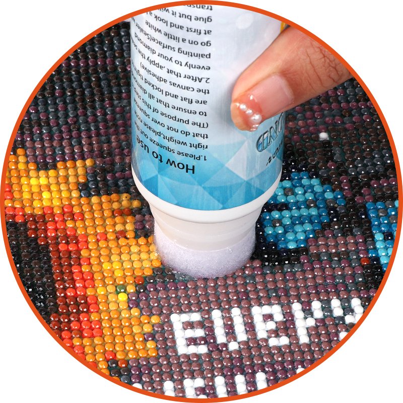 Diamond painting sealer bottle with sponge applicator being used on a diamond art canvas. Instructions are visible on the bottle.