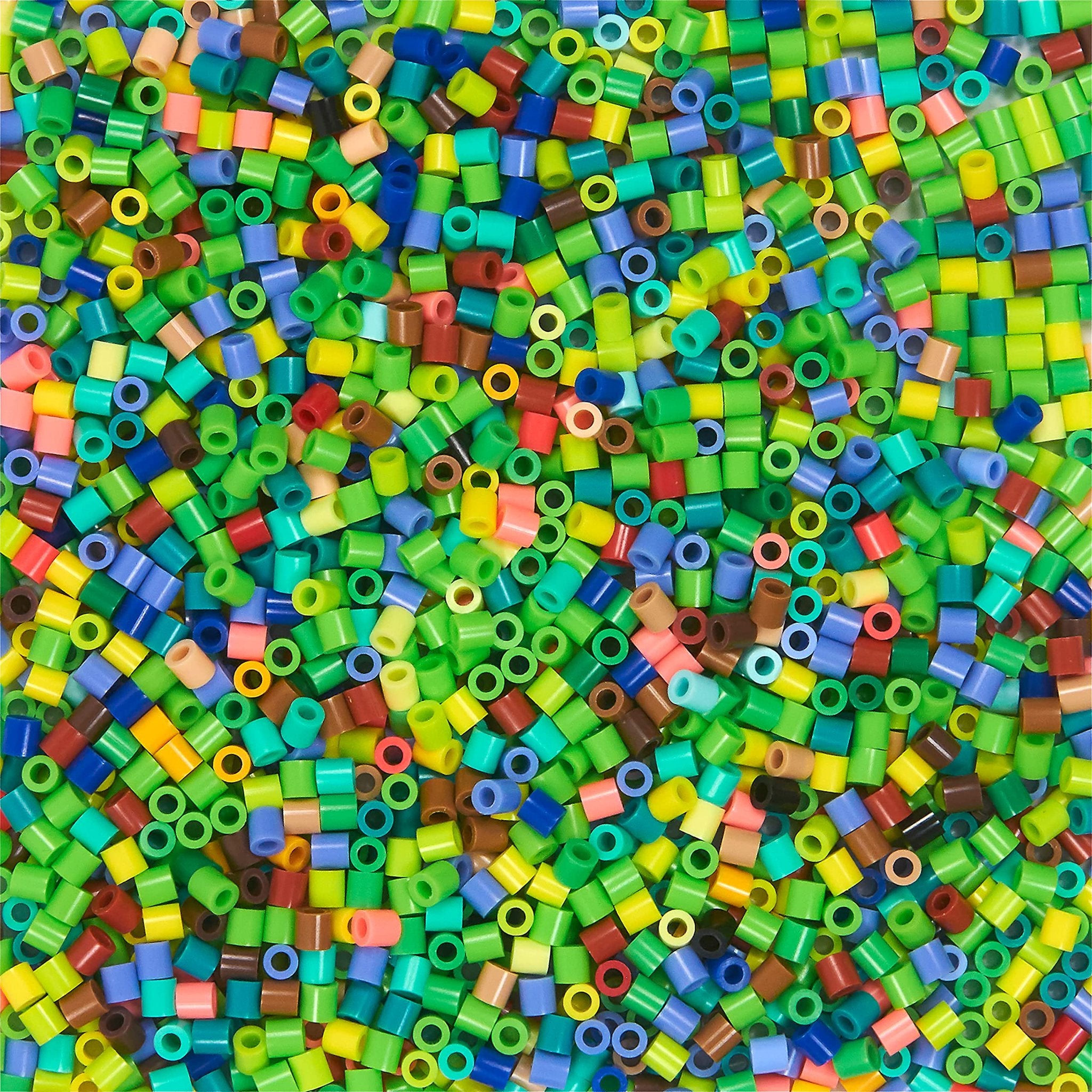 Pile of colorful fuse beads in various shades of green, blue, red, yellow, and brown.