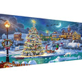 Diamond painting kit showing a snowy Christmas village scene with a decorated tree, houses, snowman, and sleigh.