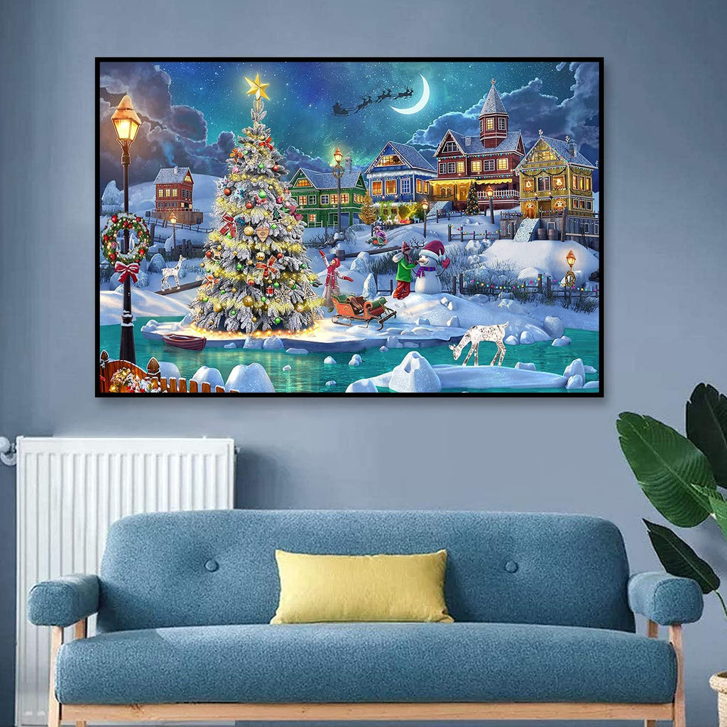 Diamond painting kit showing a snowy Christmas village scene with a decorated tree, snowman, and houses under a crescent moon.