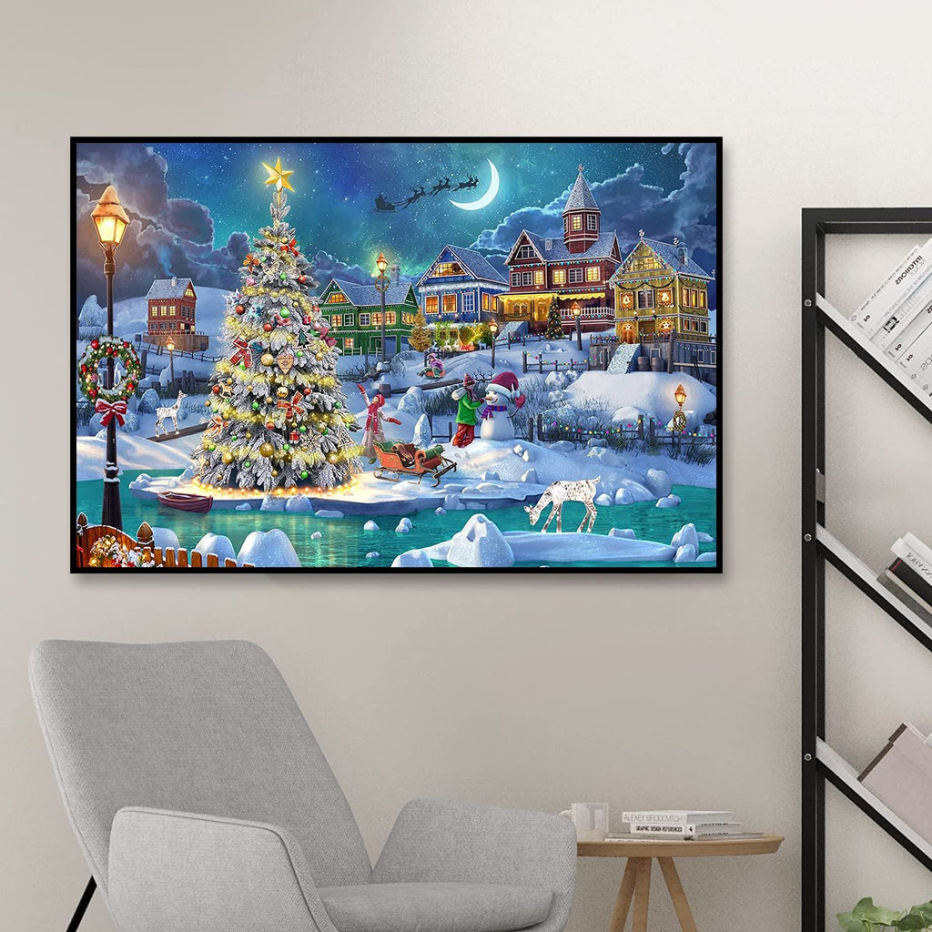 Diamond painting kit showing a snowy Christmas village scene with a decorated tree, houses, and a crescent moon.