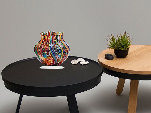 Colorful 5D special shaped acrylic tabletop ornament vase on a black table with decorative stones