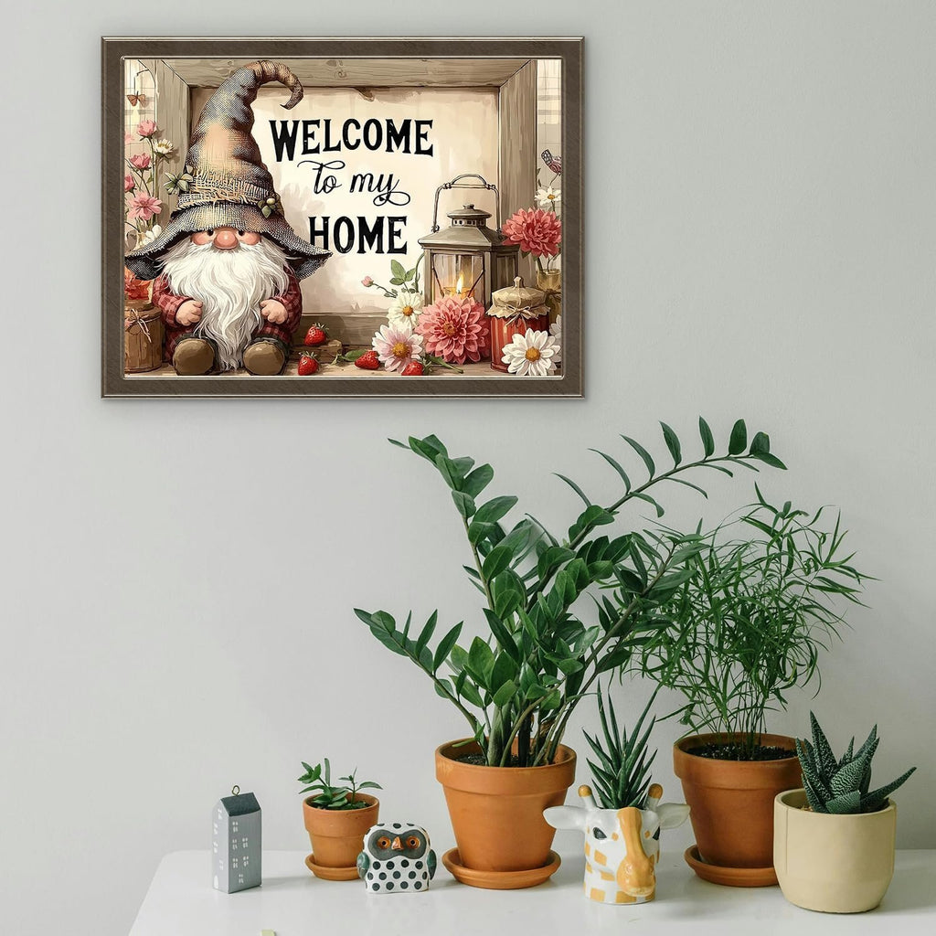 Framed artwork of a gnome with flowers and a lantern, with text 'Welcome to my HOME'.