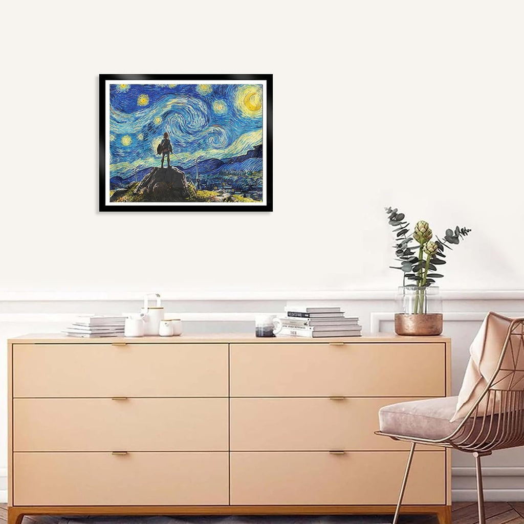 Framed diamond art painting of a figure standing on a rock under a starry night sky, displayed above a dresser.