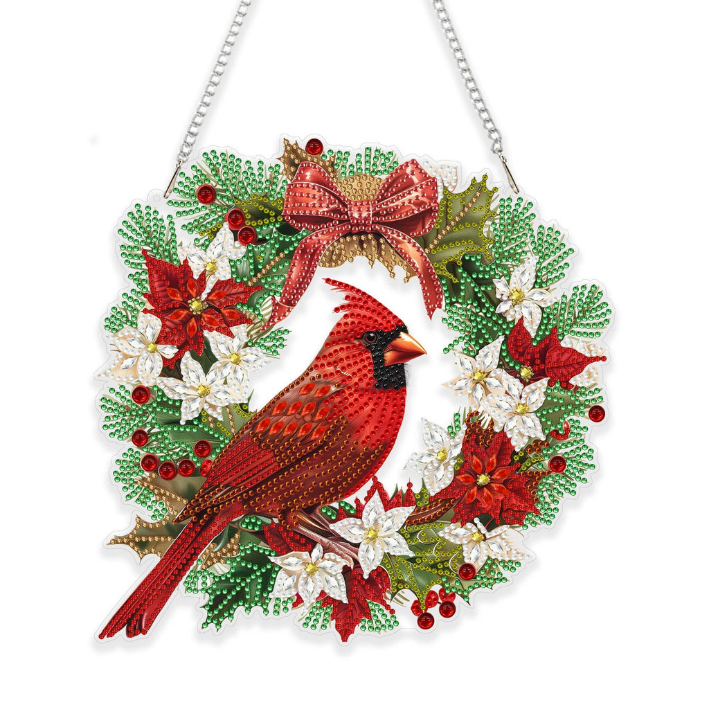 Diamond art cardinal bird hanging ornament with poinsettias and holly on a white background