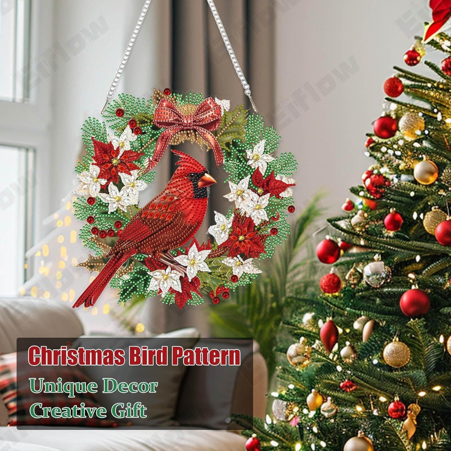 Diamond art cardinal bird wreath ornament hanging near a decorated Christmas tree