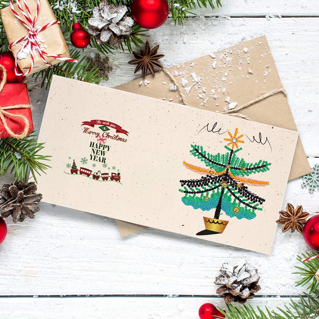 Diamond painting Christmas card with a festive tree and holiday greeting, surrounded by pine branches and ornaments.