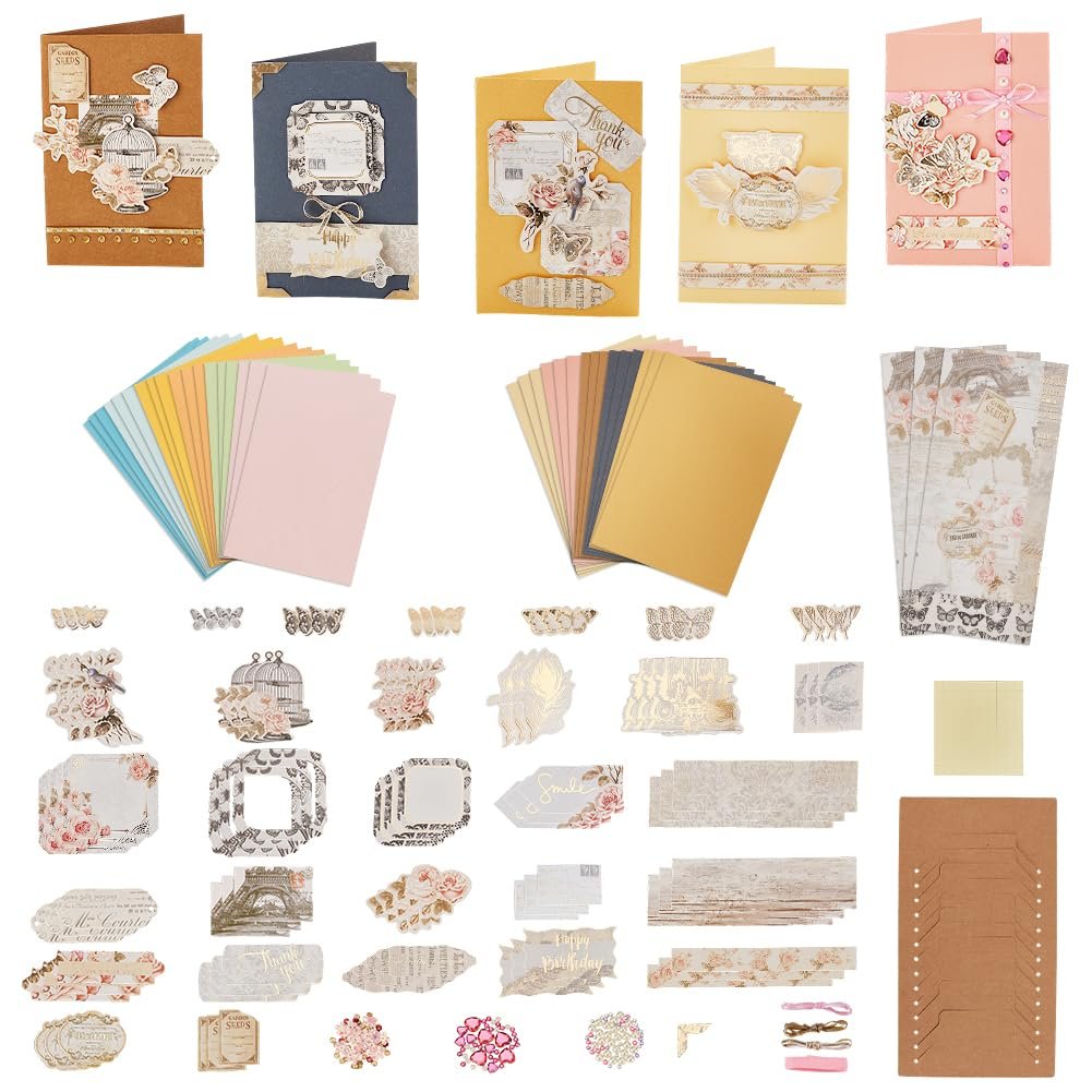 DIY envelope and card making kit contents including paper, stickers, and decorative materials.