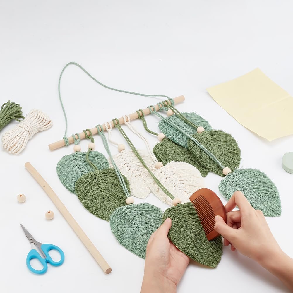 Macrame leaf wall hanging kit components with hands combing a leaf shape on a white background