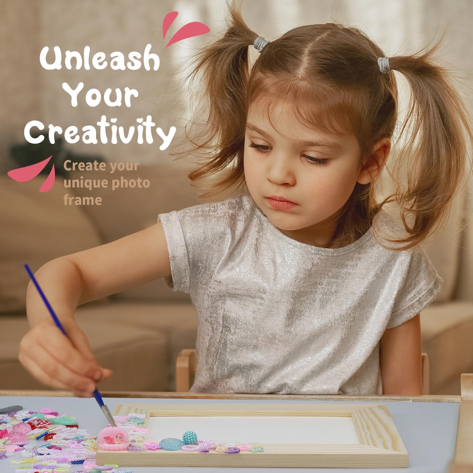Young girl with pigtails decorating a wooden picture frame with colorful mosaic pieces and a brush.