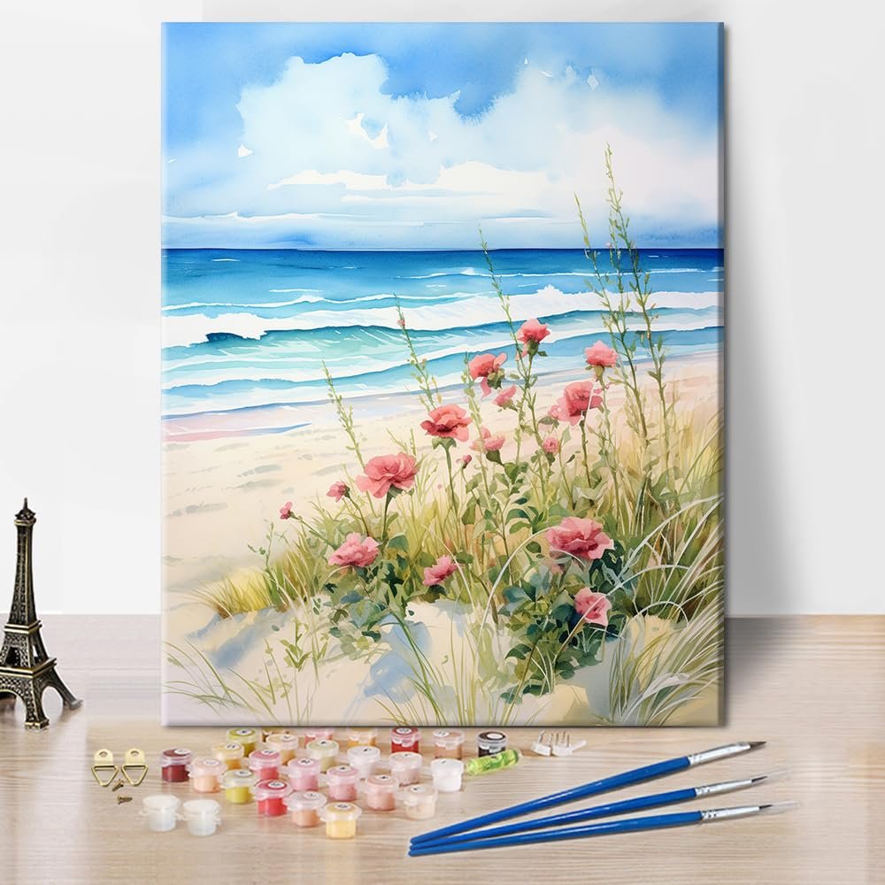 Paint by numbers kit with beach scene, pink flowers, and ocean waves, includes acrylic paints and brushes.